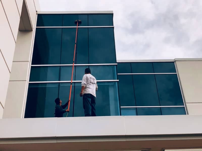 Professional workers performing commercial window cleaning